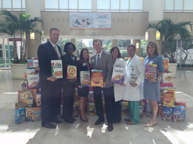 staff holding cereal for food drive